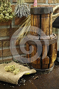 Antique pitchfork and wooden wheel hub on burlap sack against ru