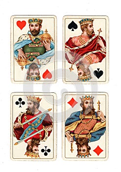 Antique playing cards showing four kings.