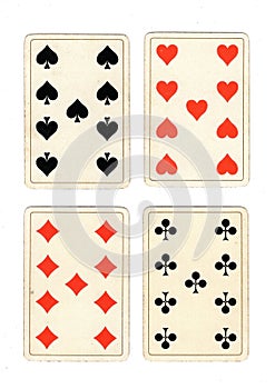 Antique playing cards showing four nines. photo