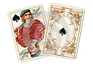 Antique playing cards showing a jack and ace of spades.
