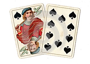 Antique playing cards showing a jack and ten of spades.
