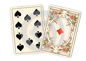 Antique playing cards showing a ten and ace.