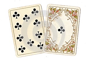 Antique playing cards showing a ten and ace of clubs.