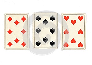 Antique playing cards showing three eights.