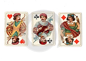 Antique playing cards showing three jacks.