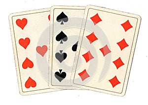 Antique playing cards showing three nines. photo