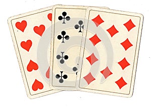 Antique playing cards showing three tens.