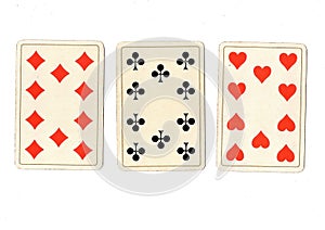 Antique playing cards showing three tens.