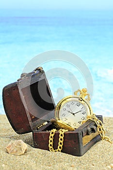 Antique pocket clock in a treasure chest