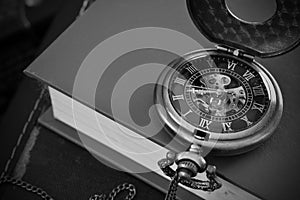 Antique Pocket Watch and Old Book