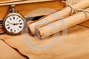 Antique pocket watch and paper rolls