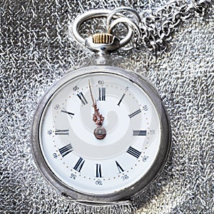 antique pocket watch on silver cloth close up