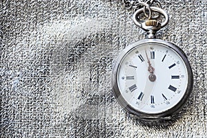 antique pocket watch on silver textile background