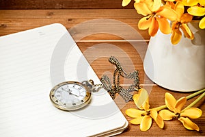 Antique pocket watch with yellow gardenia flower