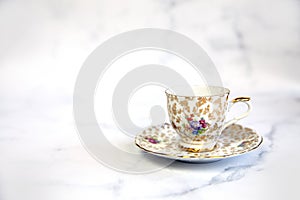 Antique porcelain tea cup on white background copy space. traditional English vintage ceramics