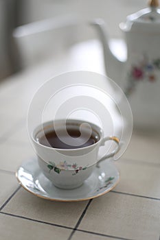 antique porcelain tea set on white background. cup of tea and a kettle on a table