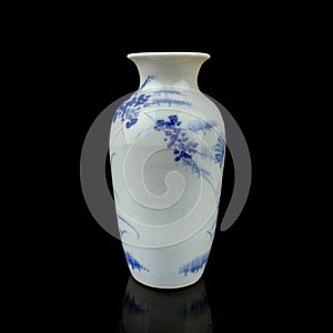 Antique porcelain vase in oriental style on a black isolated background.