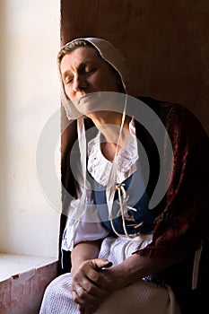 Antique portrait of woman at window