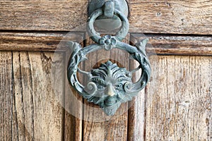 Antique pull handle knob on a vintage wooden door. Architectu photo