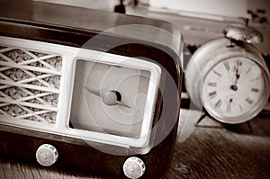 Antique radio, alarm clock and typewriter, in sepia toning photo