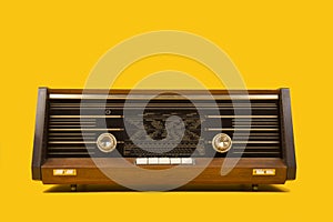 Antique radio seen from the front on a yellow background