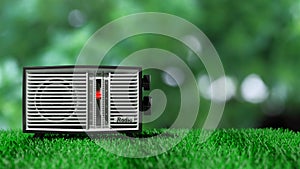 Antique radio transistor on green grass