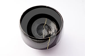 Antique raku black bowl restored with antique kintsugi real gold technique