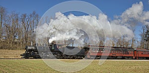 Antique Restored Steam Passenger Train Blowing Smoke and Steam