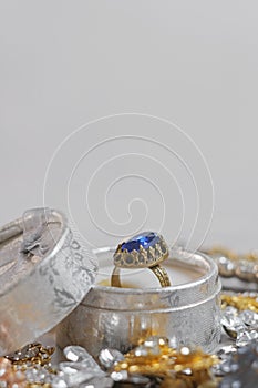 Antique ring with blue gemstone in box and jewel set. Beautiful fashion and vintage jewelry with precious shiny stones, pearls and