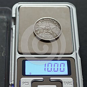 Antique Russian silver coin 50 kopecks 1921 on scales on black background photo