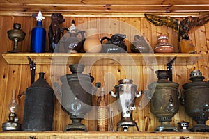 Antique samovars on a shelf on a wooden background