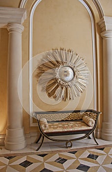 Antique settee and starburst convex mirror