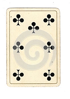 An antique seven of clubs playing card.