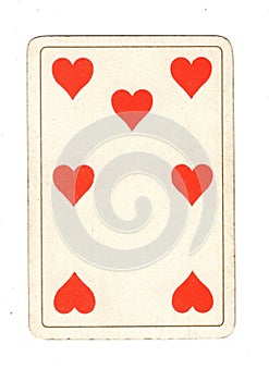 An antique seven of hearts playing card.