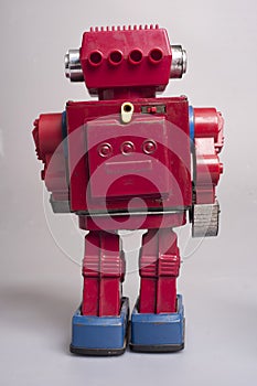 Antique sheet metal toy robots from the year 1950, battery operated, artificial intelligence, robotics concept, on gray background