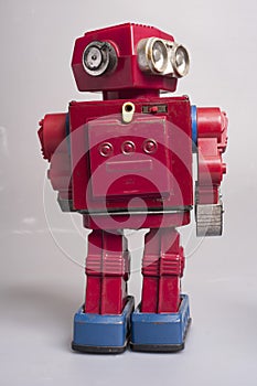 Antique sheet metal toy robots from the year 1950, battery operated, artificial intelligence, robotics concept, on gray background