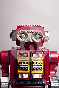 Antique sheet metal toy robots from the year 1950, battery operated, artificial intelligence, robotics concept, on gray background