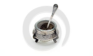 Antique silver salt shaker with spoon.