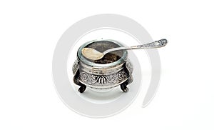 Antique silver salt shaker with spoon.