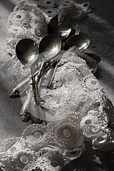 Antique silver spoons with handmade embroidery napkin