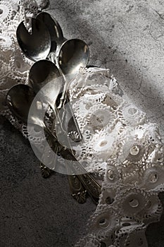 Antique silver spoons with handmade embroidery napkin