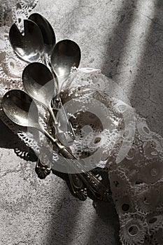 Antique silver spoons with handmade embroidery napkin