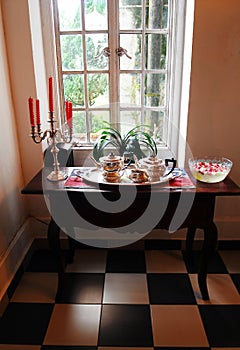 Antique silver tea service set by window