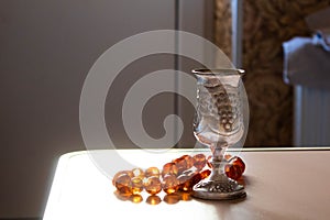 Antique silver wine glass and beads made of natural amber