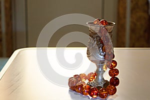 Antique silver wine glass and beads made of natural amber