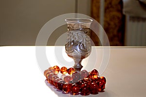 Antique silver wine glass and beads made of natural amber