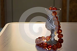 Antique silver wine glass and beads made of natural amber