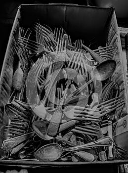 Antique silverware in a bin