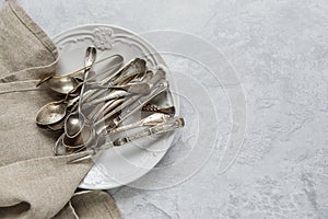 Antique silverware on ceramic plate