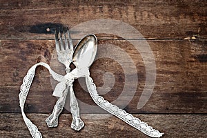 Antique Silverware over a Rough Wooden Background
